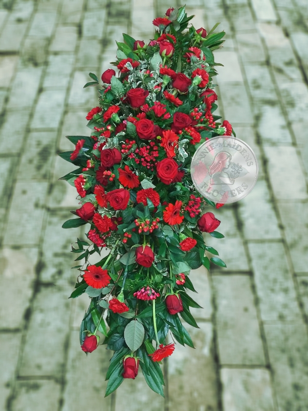 Large casket spray of mixed all red flowers