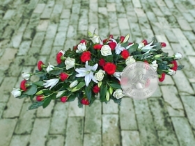 White lily with red and white roses and carnations coffin spray