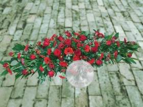 Large casket spray of mixed all red flowers
