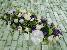 White and purple casket spray